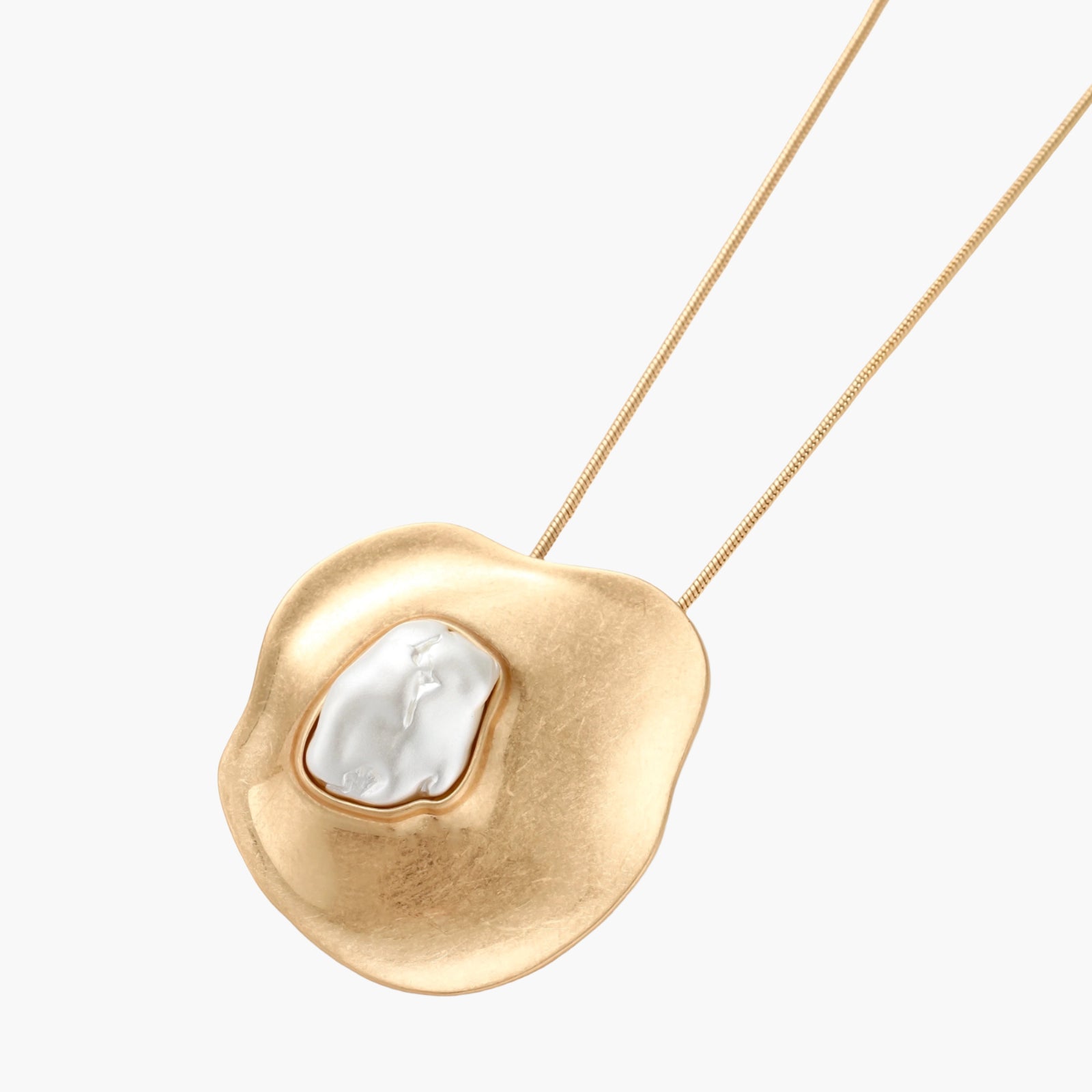 Organic-shaped gold pendant necklace with baroque pearl accent on adjustable chain, displayed against neutral background.