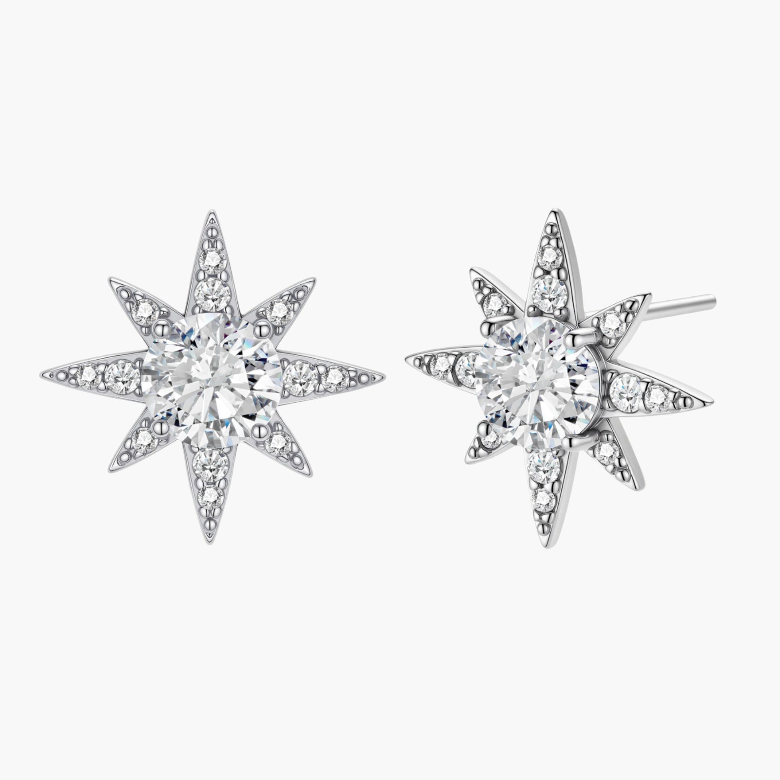 Sterling silver star-shaped stud earrings with brilliant moissanite center stones and pavé details on neutral background.