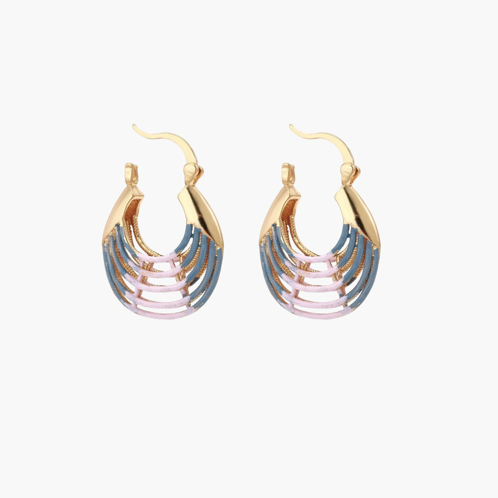 Gold hoop earrings with gradient blue-to-pink enamel in ribbed fan design on beige background