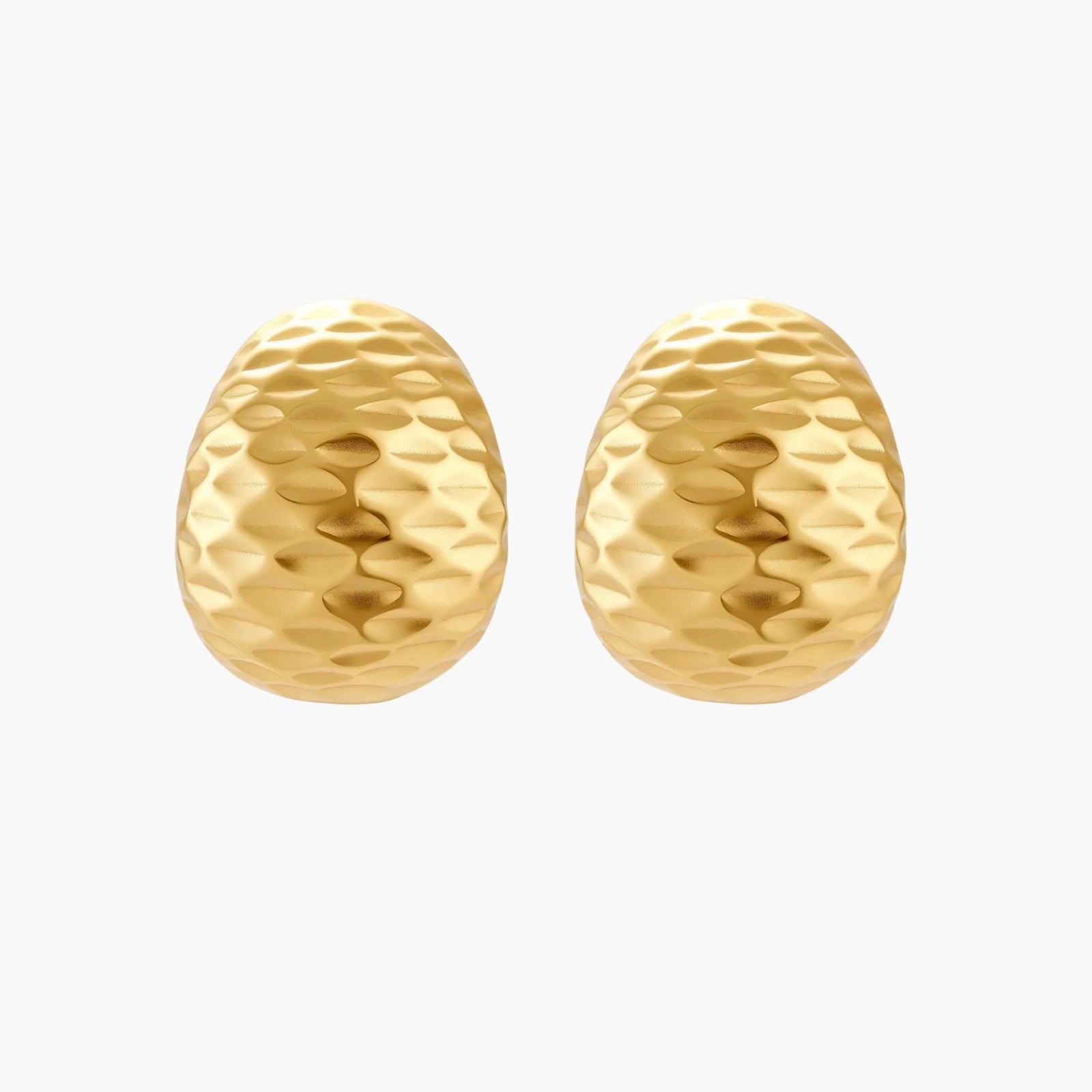 Pair of textured gold-plated sterling silver huggie earrings with dimpled surface finish on cream background.