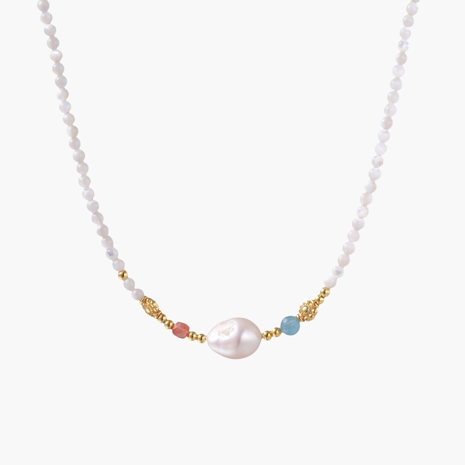 Delicate white beaded necklace with baroque pearl center, gold accents, and coral and aqua gemstones on cream background.