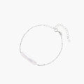 Minimalist bracelet with iridescent baroque pearl on rhodium-plated sterling silver chain against cream background