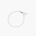 Adjustable bracelet featuring lustrous freshwater pearls with rhodium-plated sterling silver clasp on cream background.