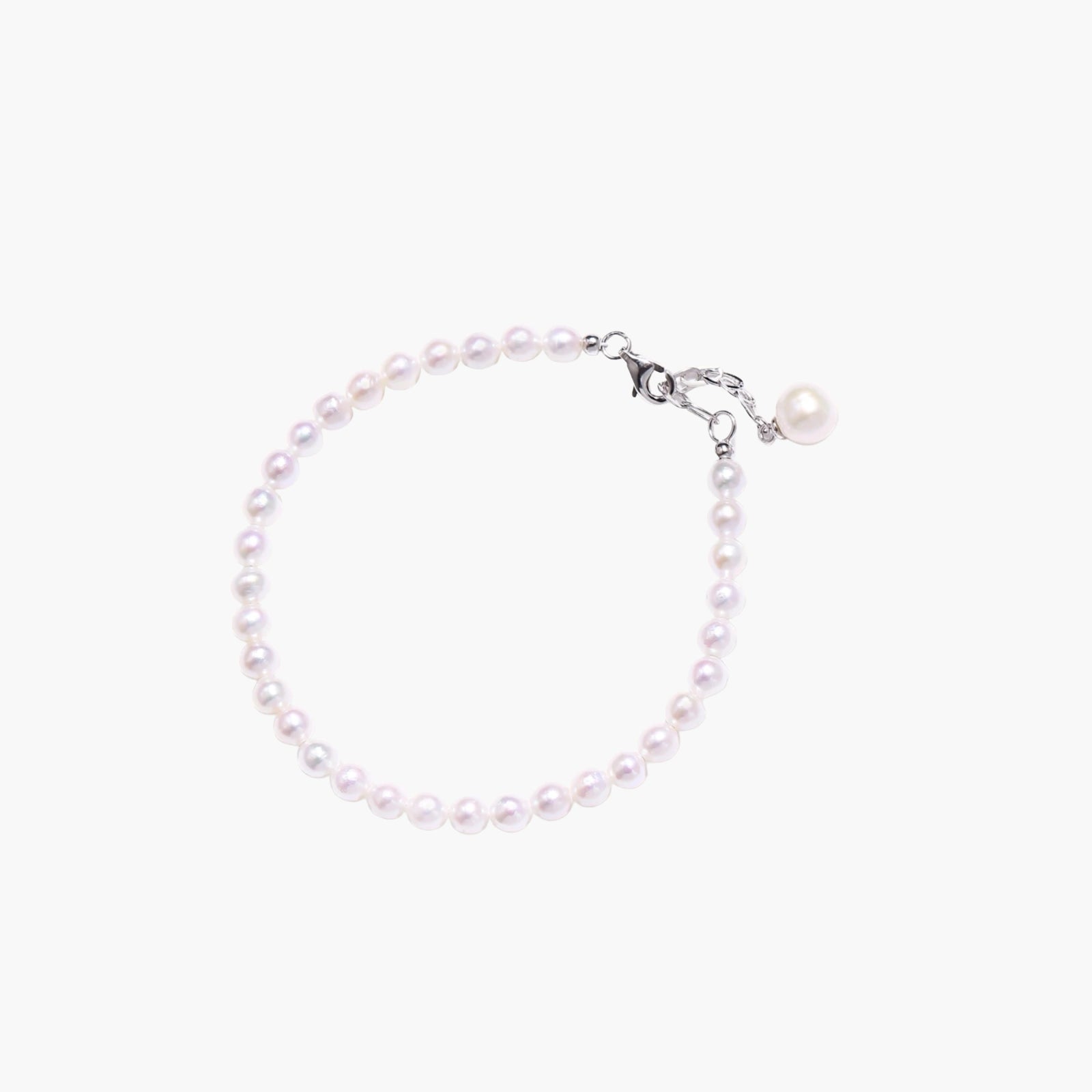 Adjustable bracelet featuring lustrous freshwater pearls with rhodium-plated sterling silver clasp on cream background.