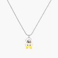 Chrome egg-shaped pendant with kawaii face, yellow bow, and pearl detail on silver chain against white background