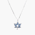 White gold-plated lotus pendant with blue denim fabric inlay and sparkling zirconia stones on adjustable chain