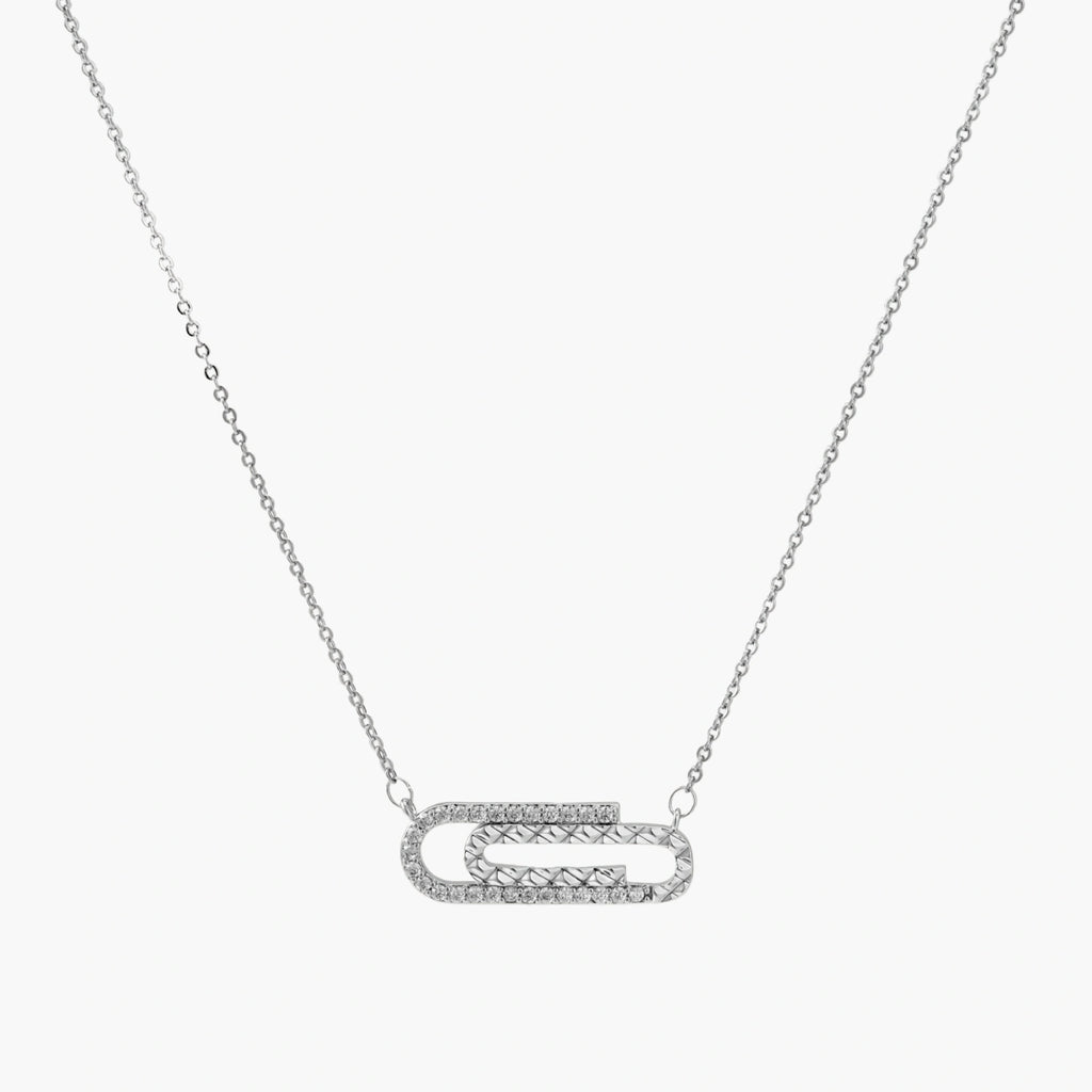 White gold plated necklace with dual-frame geometric pendant featuring crystal pavé border on pale background.