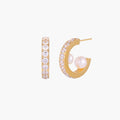 Gold pavé hoop earrings with two freshwater pearls nestled inside the curved design, featuring crystal-studded outer edge.