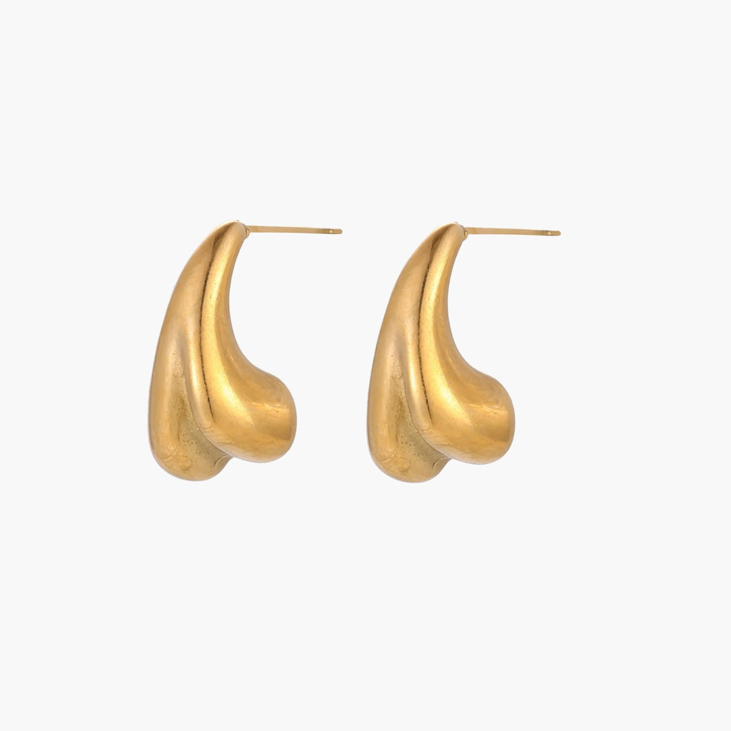 Organic sculptural gold stud earrings with fluid matte finish on cream background