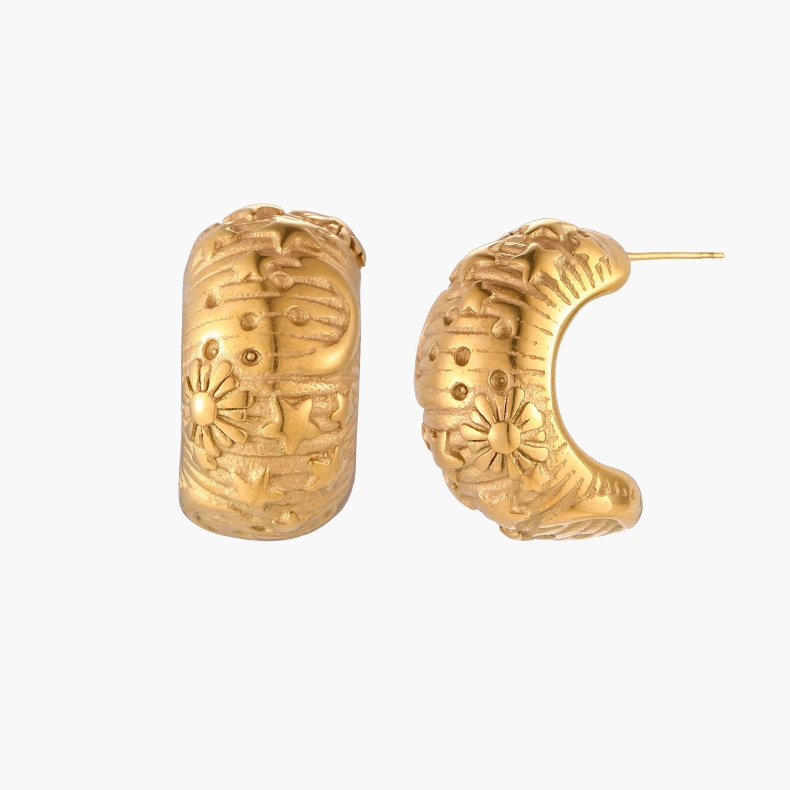 Wide gold hoop earrings with embossed stars and sun motifs on cream background, showing dimensional relief details.