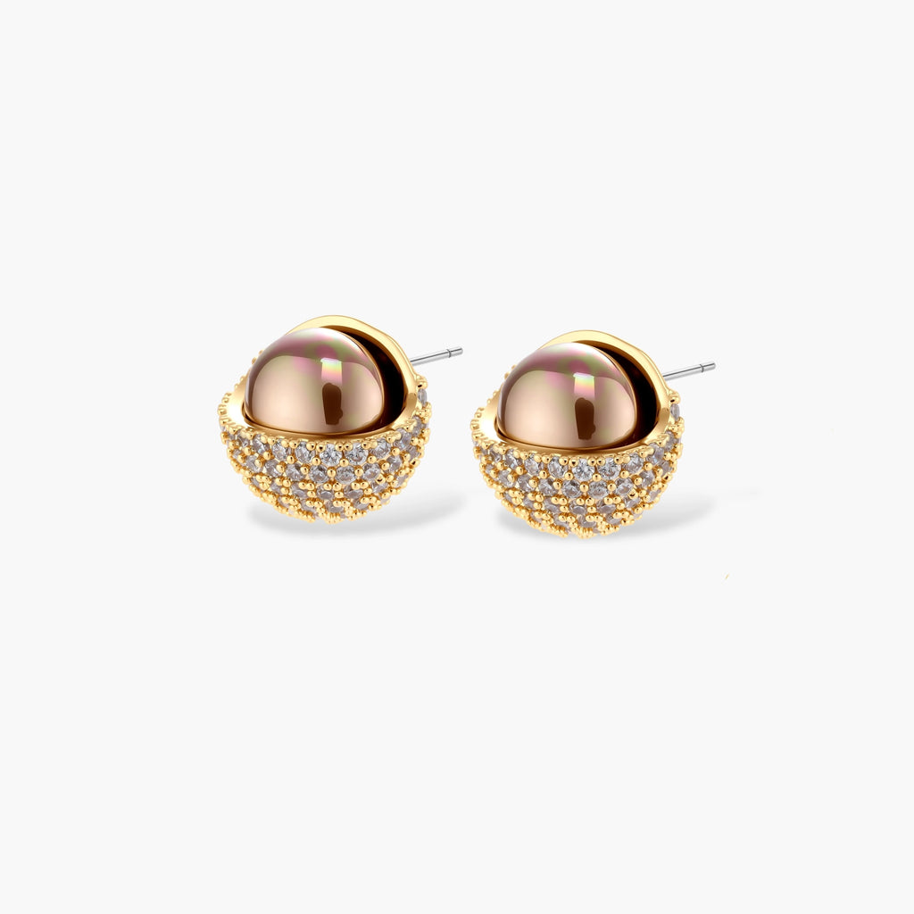 Elegant spherical pendant necklace and earrings set featuring crystal-pavé bottom half in gold or silver finish on white background.