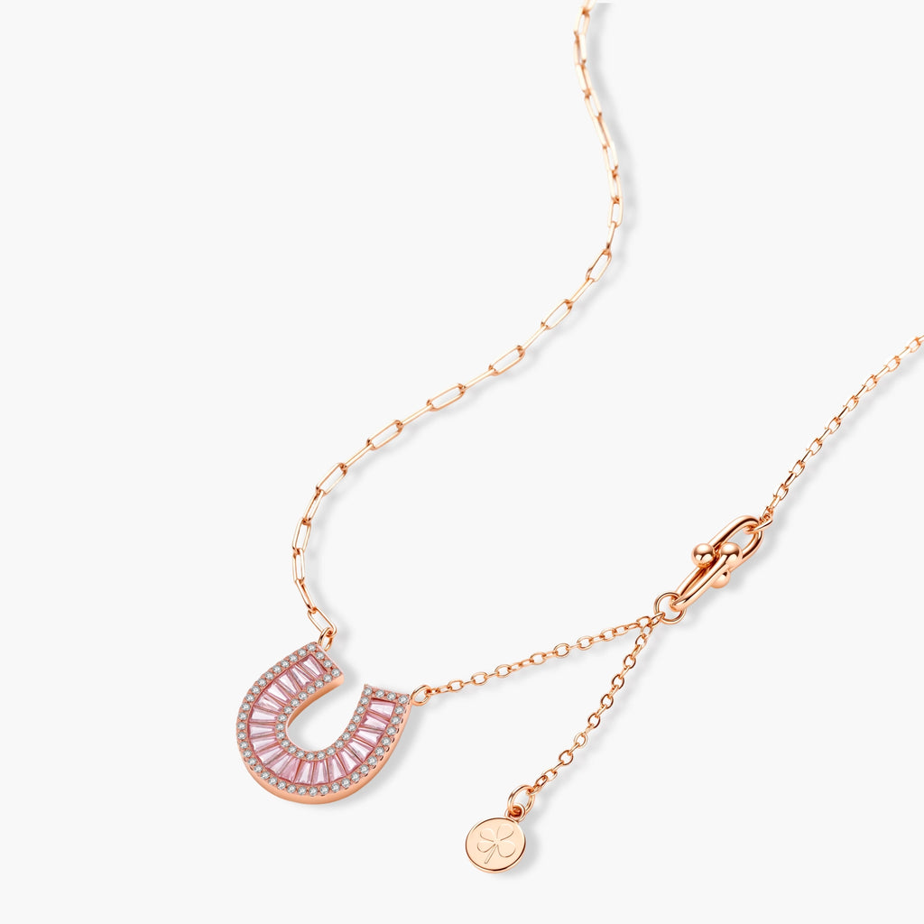 Sparkling horseshoe-shaped jewelry set with AAA cubic zirconia in gold-plated and white gold finishes on cream background.
